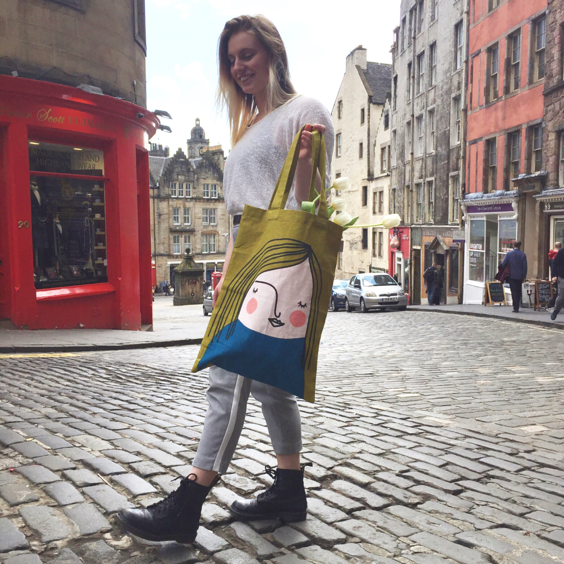 Anoushka walking up victoria street with a spira face tote bag