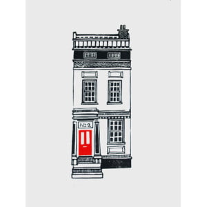 A black and white town house with a red door